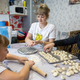 family making dumplings in kitchen